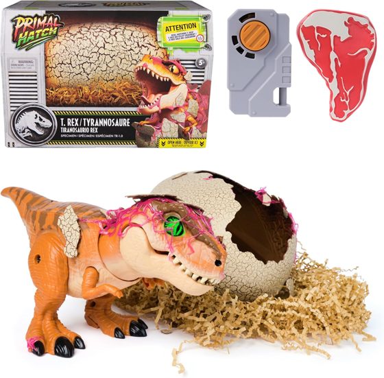 Primal Hatch Jurassic World T-Rex toy dinosaur beside its cracked hatching egg with clicker and toy steak